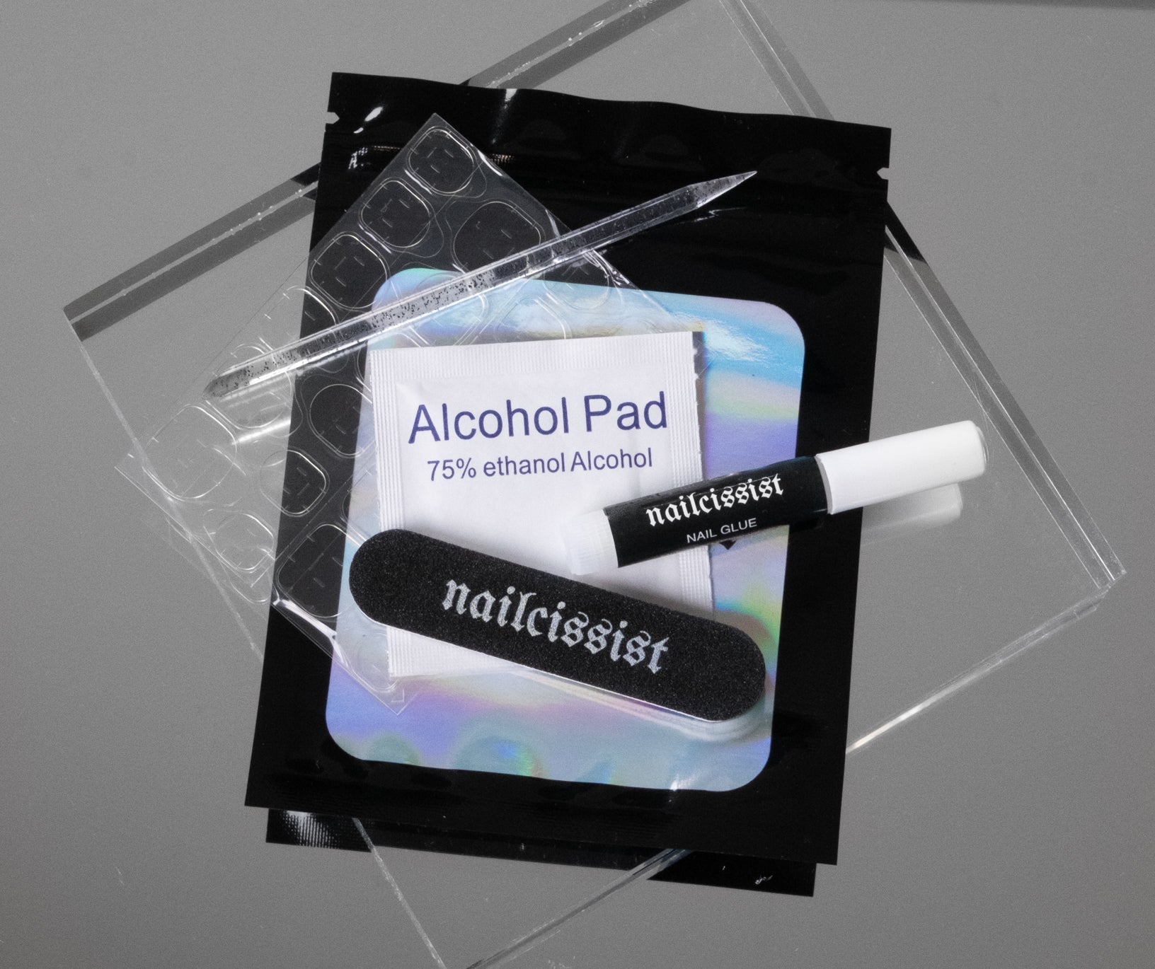 Complimentary nail file, alcohol swap, sticky tabs, cuticle pusher and nail glue kit